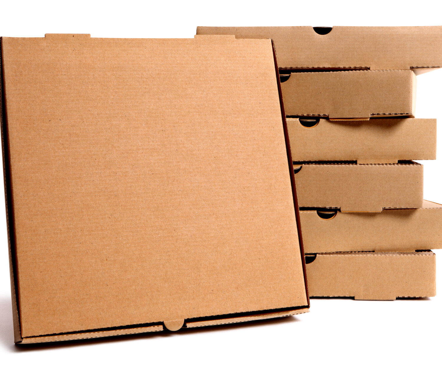 Stack of plain brown pizza boxes with one front facing box for display or advertising.  Isolated on white background.  Copy space.