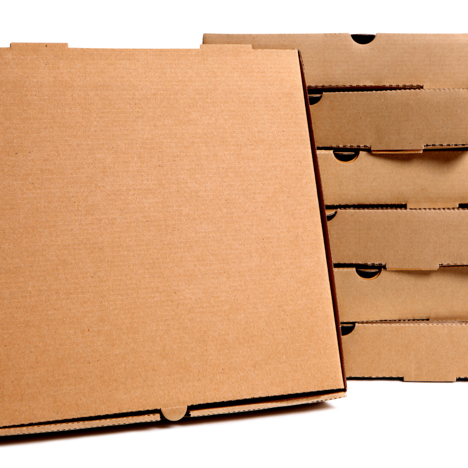 Stack of plain brown pizza boxes with one front facing box for display or advertising.  Isolated on white background.  Copy space.